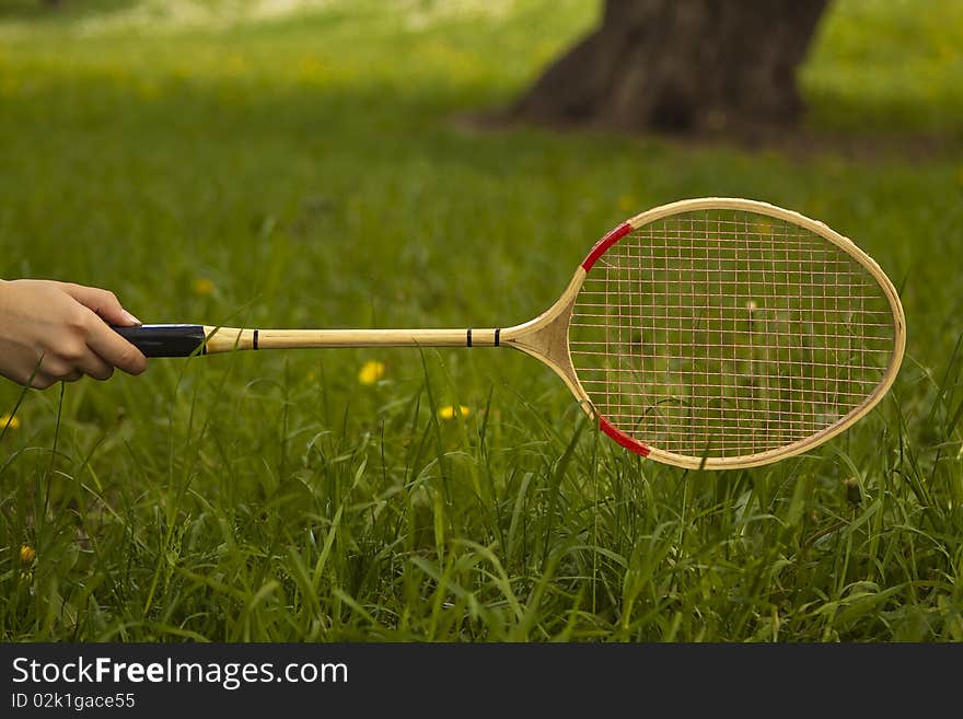 A human hand holding a tennis racket