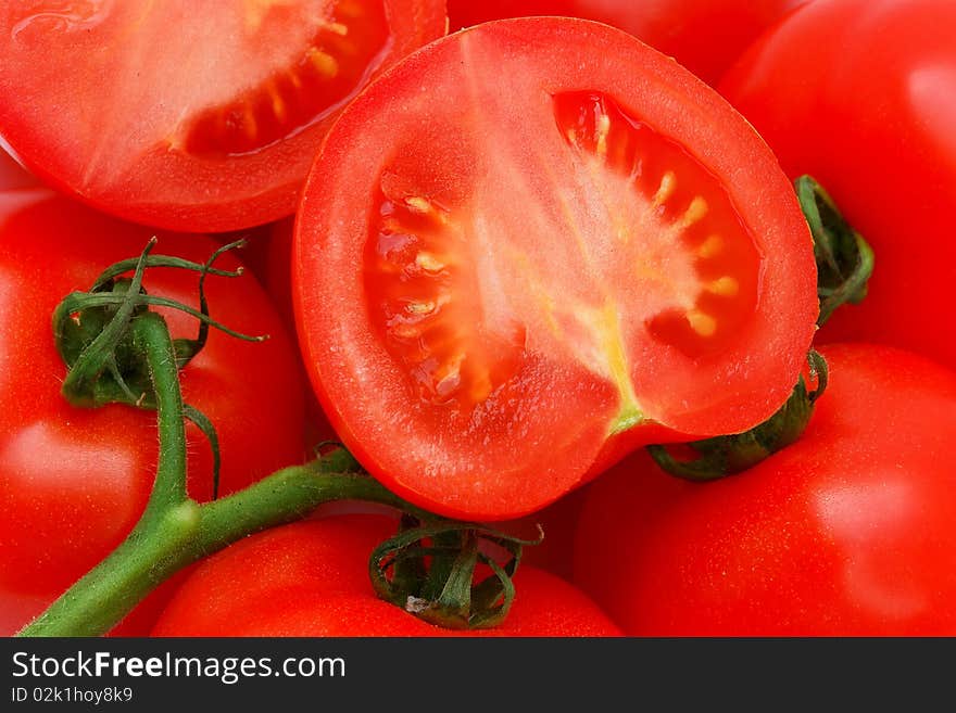 Ripe red  tomatoes on a green twig