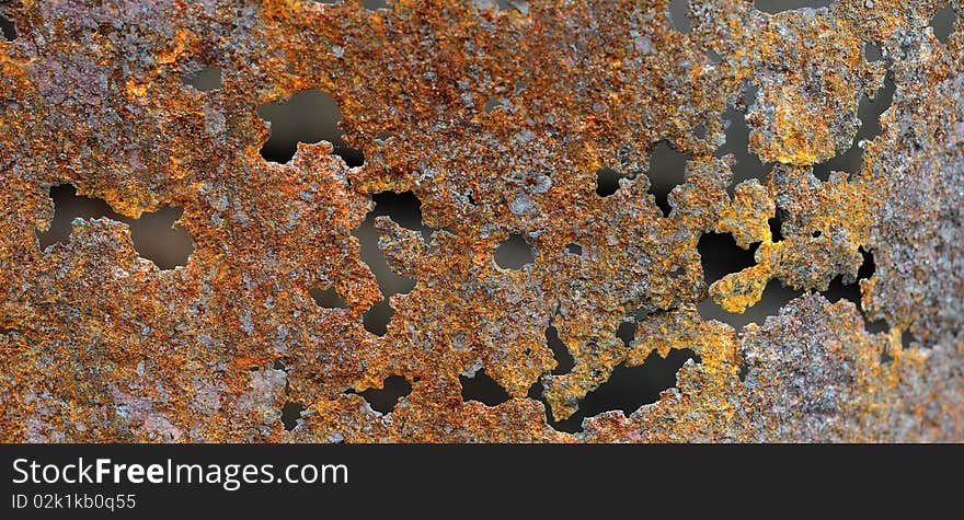 Rust texture originally from an old burn barrel. gritty brown and orange colors with holes. Rust texture originally from an old burn barrel. gritty brown and orange colors with holes.