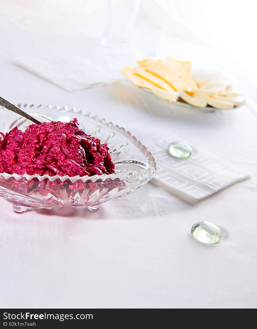 Salad from red beet on glass plate