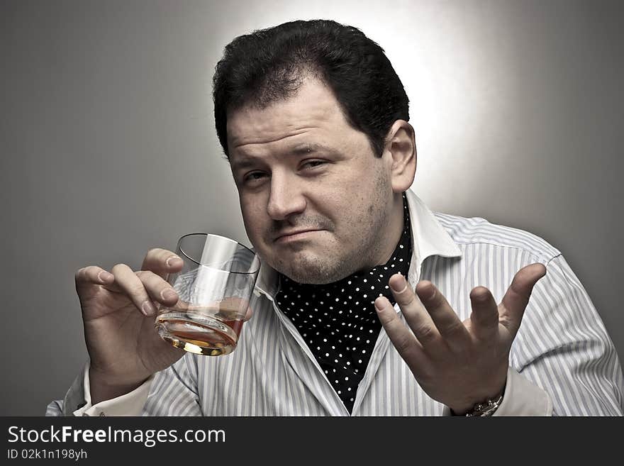 Handsome man with a glass of cognac.