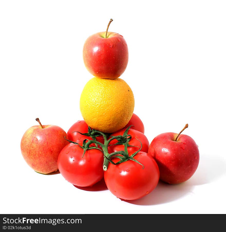 Branch of tomatos, red apples and orange with shadow isolated over white