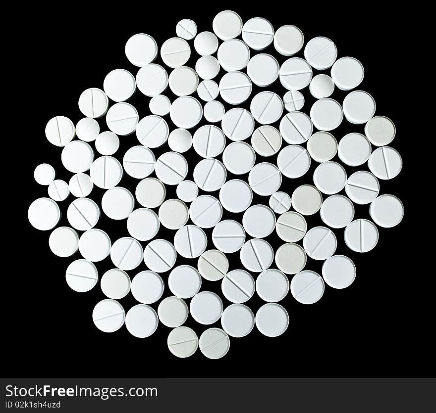 White tablets on the black background. Top view. White tablets on the black background. Top view