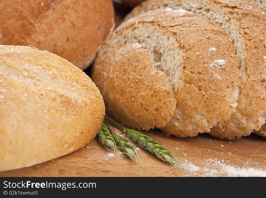 Close up of different types  bread on a wooden board sprinkled with flour