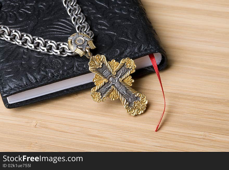 Bible and goold cross with silver chain. Bible and goold cross with silver chain