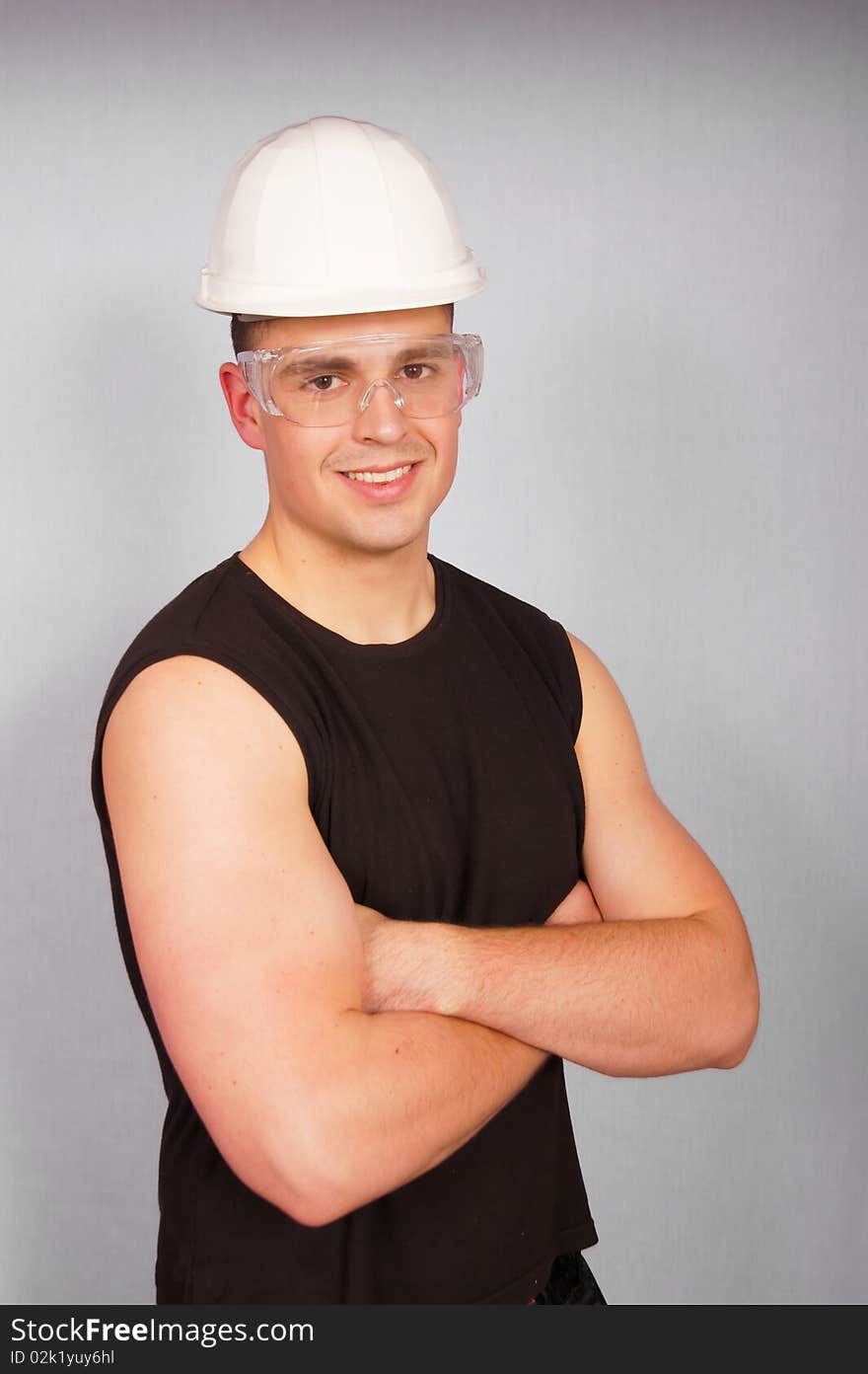 Portrait of a young smiling man in T-shirt in a helmet and goggles. Portrait of a young smiling man in T-shirt in a helmet and goggles.