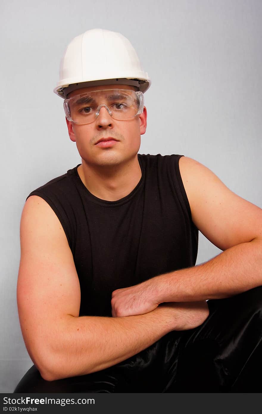 Young man in T-shirt in a helmet and goggles. You can write text on the right. Young man in T-shirt in a helmet and goggles. You can write text on the right.