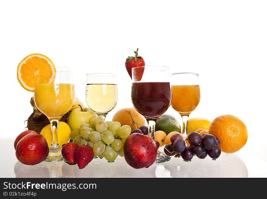 Various fruit cocktails surrounded by fresh fruit