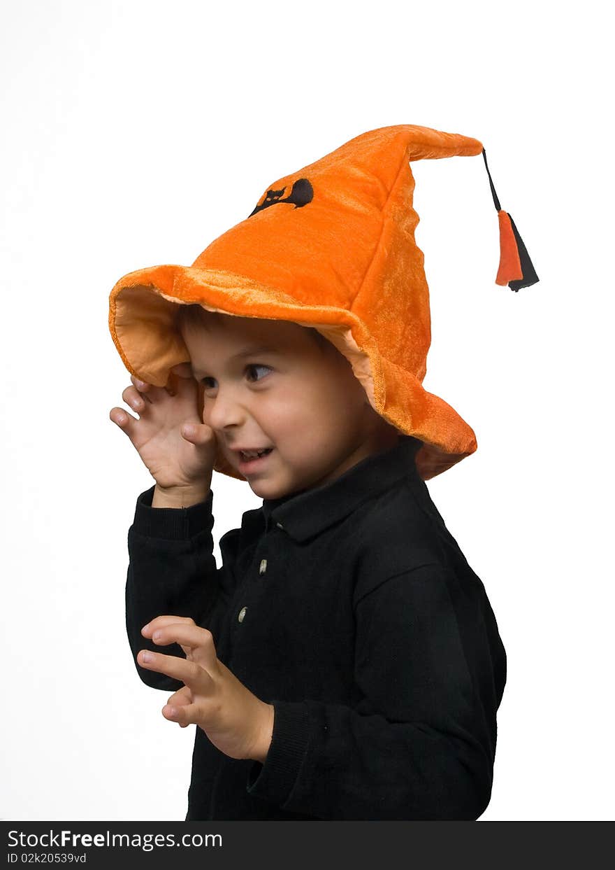 Toddler in Halloween hat tryes to scare somebody. Toddler in Halloween hat tryes to scare somebody