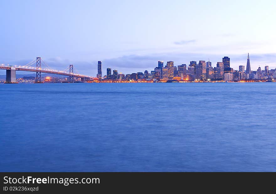 A twilight photo of the beautiful San Francisco skyline and Bay Bridge from Treasure Island. A twilight photo of the beautiful San Francisco skyline and Bay Bridge from Treasure Island.