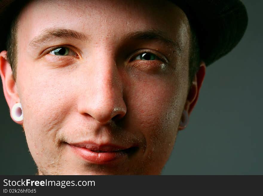 Close-up of a young man in hat