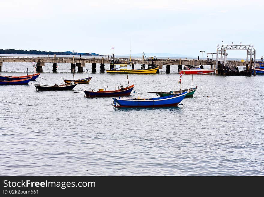 Row boats are mooring in the sea near the beach at Rayong, Thailand. Row boats are mooring in the sea near the beach at Rayong, Thailand.