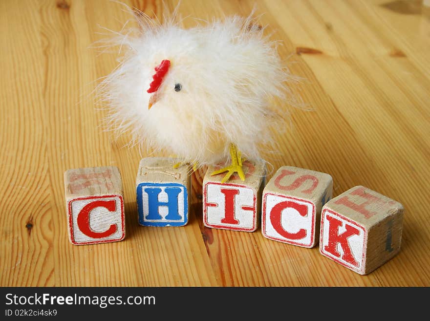 Wooden blocks spelling 'chick' with chicken. Wooden blocks spelling 'chick' with chicken