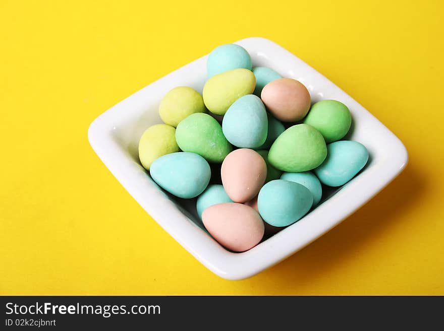 Chocolate covered candies in a dish. Chocolate covered candies in a dish