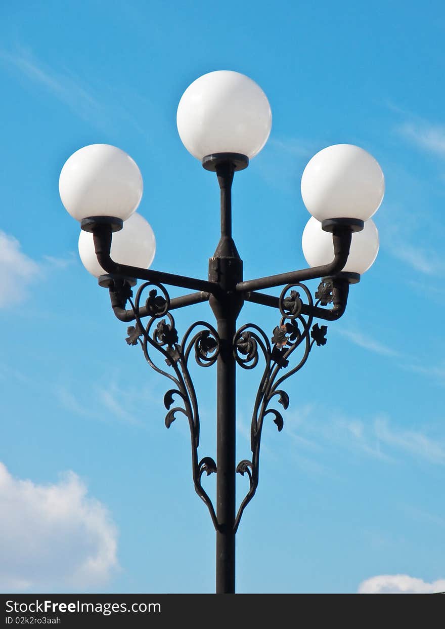 A classic street light against cloudy sky