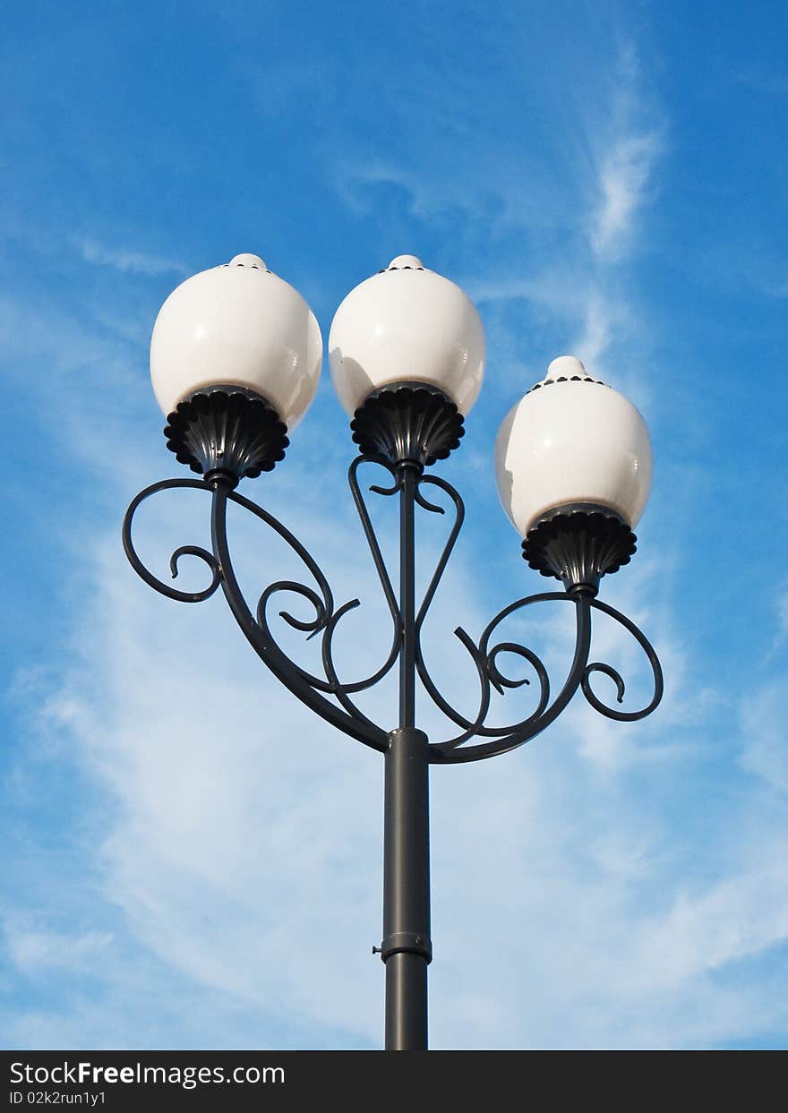 A classic street light against cloudy sky