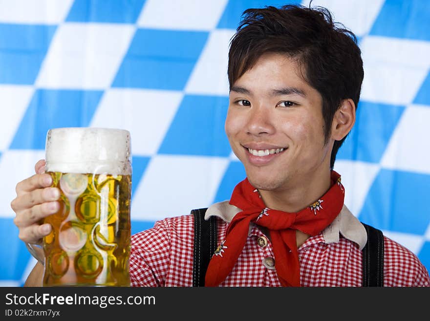 Smiling Asian holds Oktoberfest beer stein (Mass)