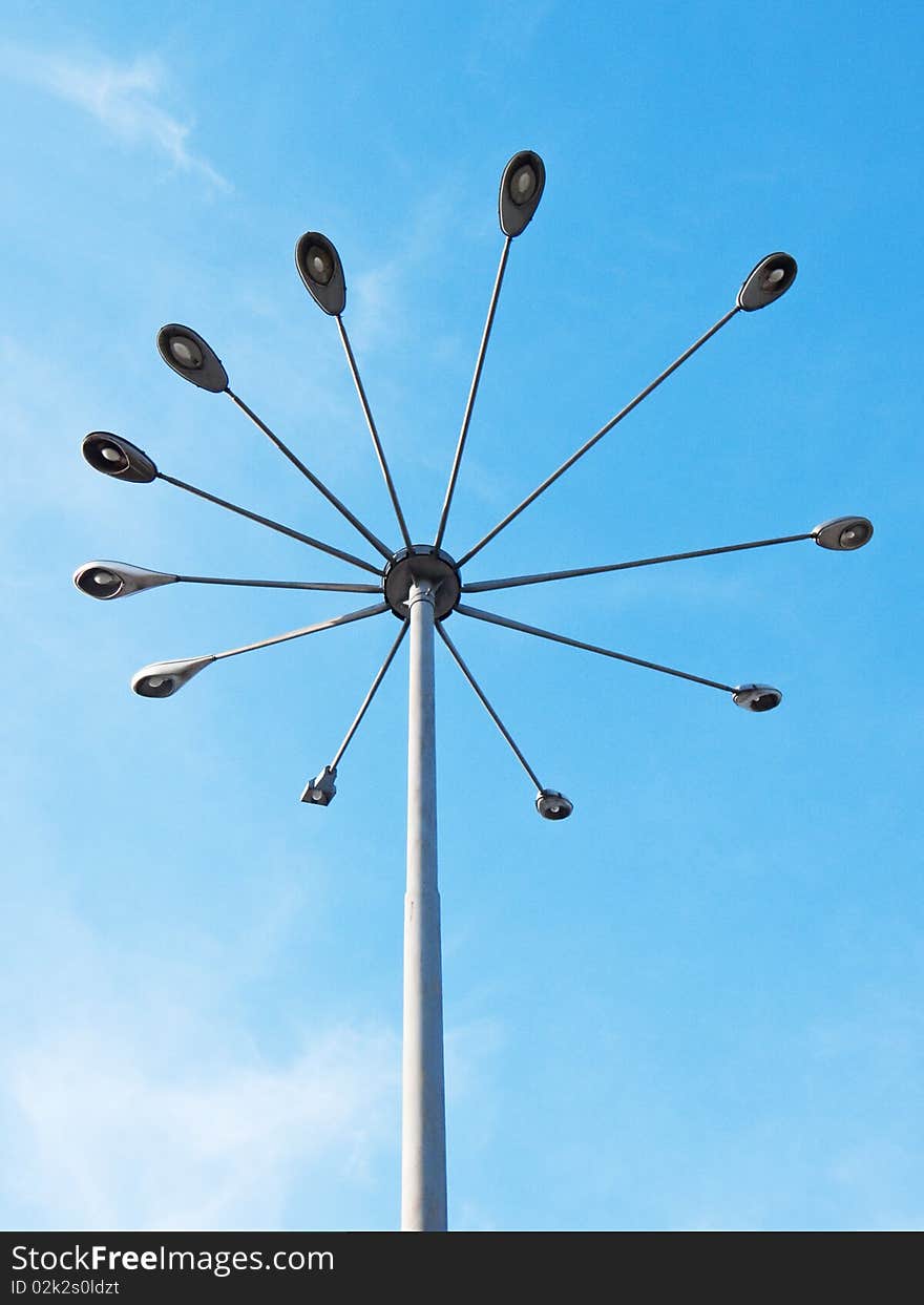 A street light in urban area, against a polarized blue sky.