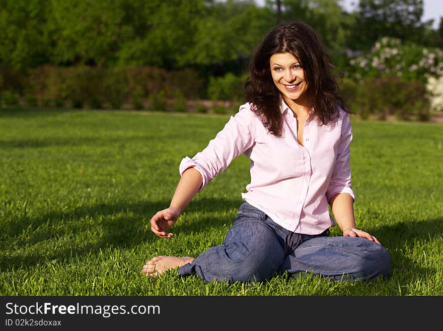 Young woman sitting on grass