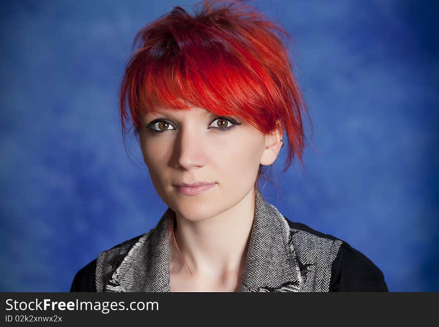 Young woman posing on a blue background. Young woman posing on a blue background