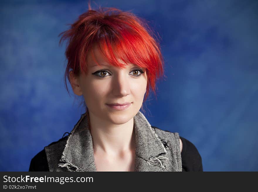 Young woman posing on a blue background. Young woman posing on a blue background