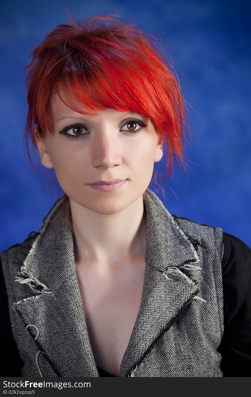 Young woman posing on a blue background. Young woman posing on a blue background