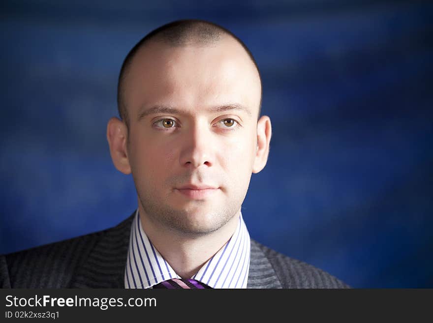 Young man posing on a blue background. Young man posing on a blue background