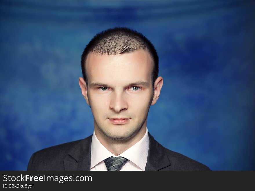 Young man posing on a blue background. Young man posing on a blue background