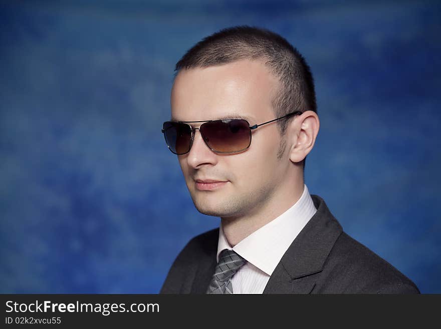 Young man posing on a blue background. Young man posing on a blue background