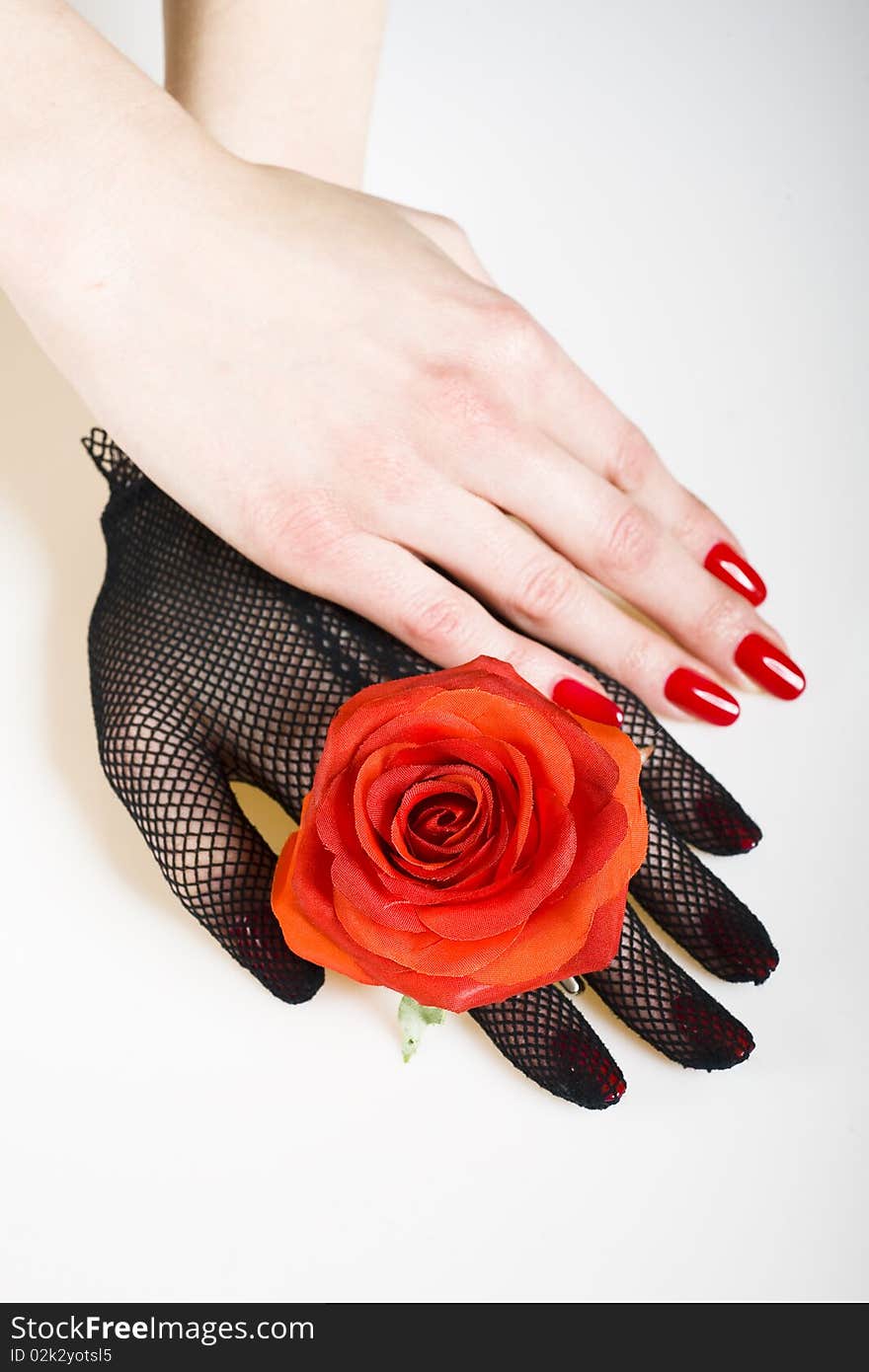 Beautiful hand with perfect nail red manicure, rose and black retro glove