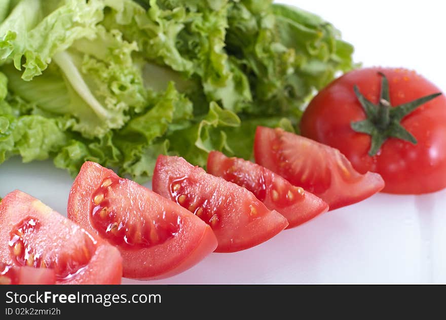 Tomato with salad, isolated on white. Tomato with salad, isolated on white