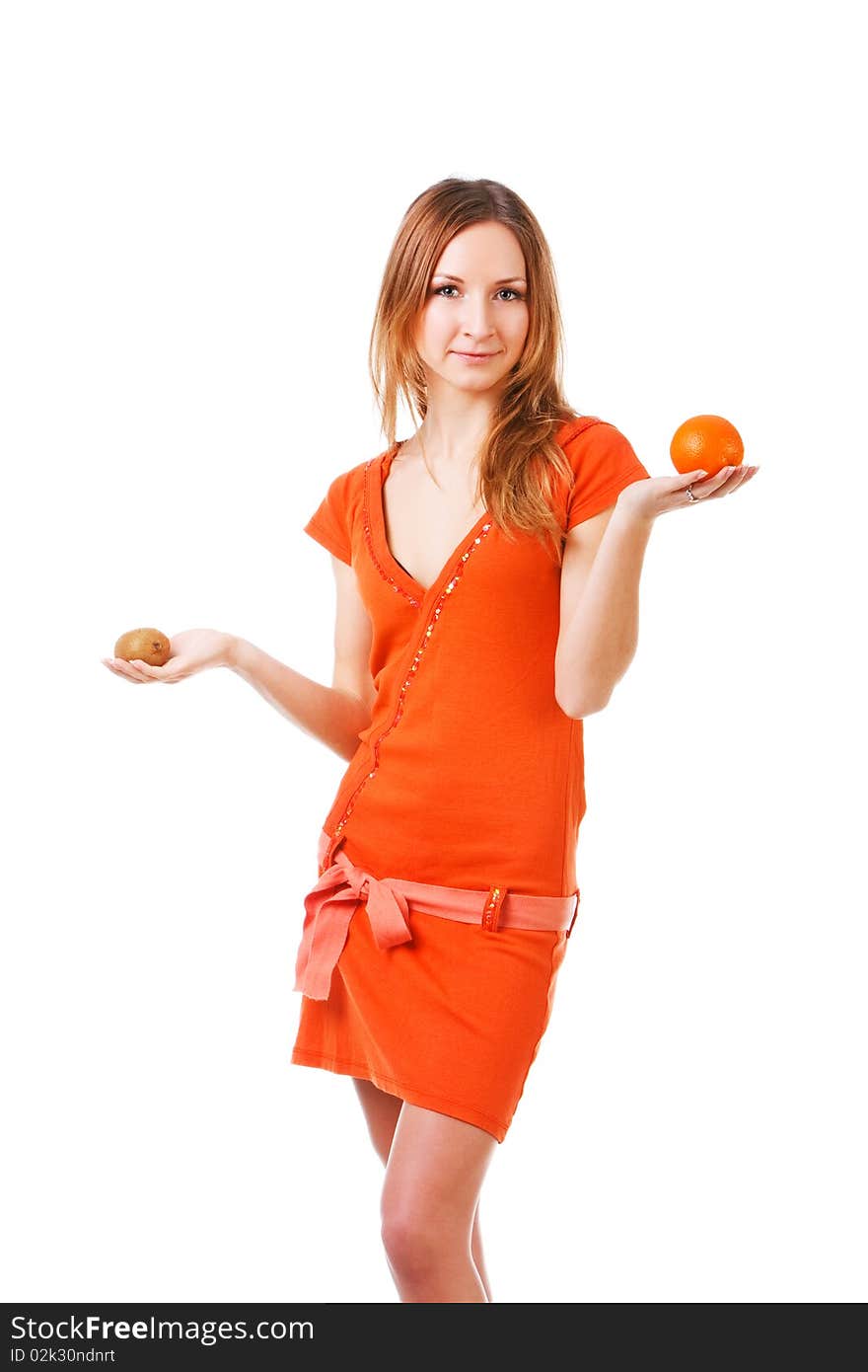 Picture of a young pretty girl in dress which holds orange and kiwi in different hands. Isolated on white. Picture of a young pretty girl in dress which holds orange and kiwi in different hands. Isolated on white.