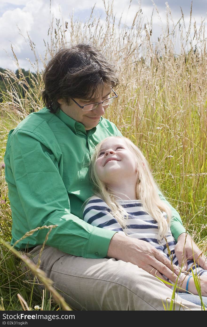 Father with daughter on meadow