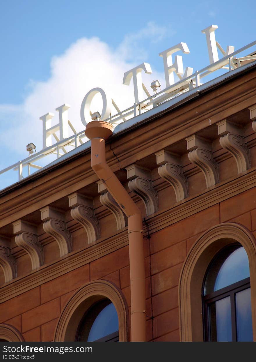 Color photo of a historic building with a sign on roof. Color photo of a historic building with a sign on roof