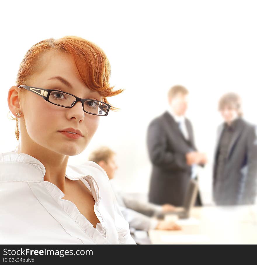 A young redhead business woman in front of a business meeting. Image isolated on a white background. A young redhead business woman in front of a business meeting. Image isolated on a white background.