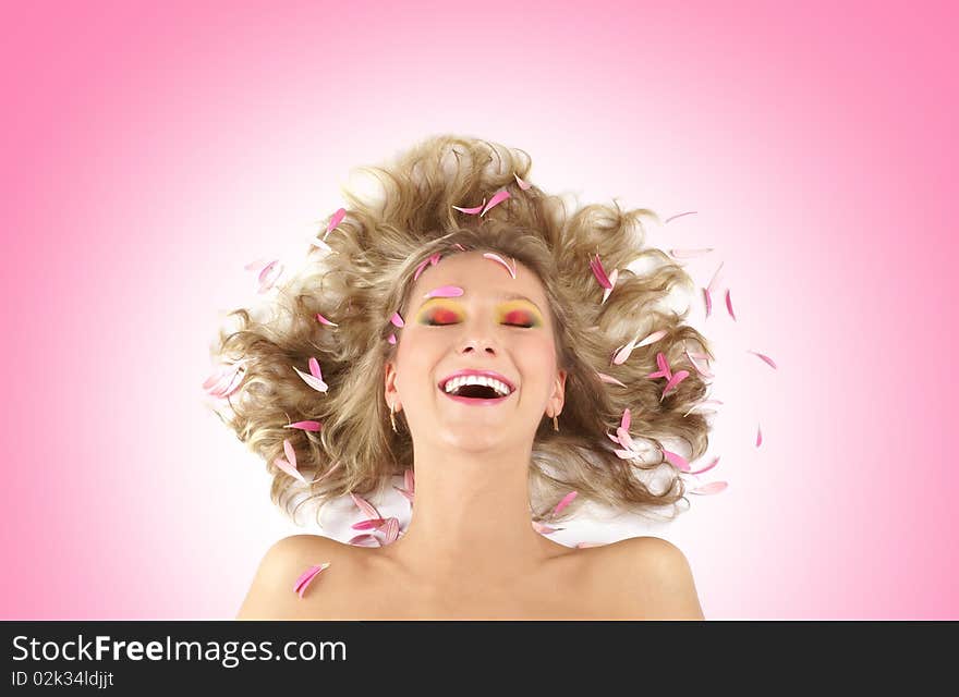 Portrait of a young and happily laughing blonde. Image isolated on a pink gradient background. Portrait of a young and happily laughing blonde. Image isolated on a pink gradient background.