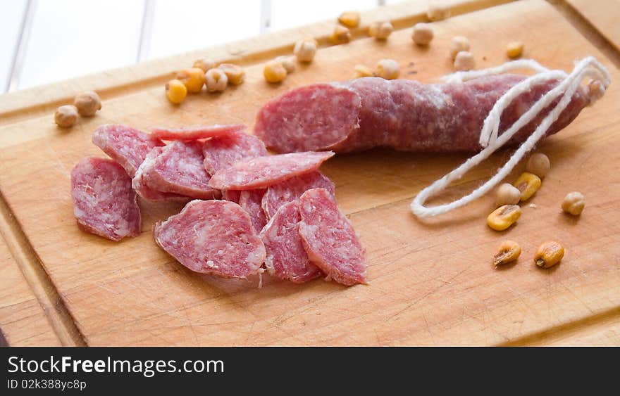 Sausage with  on a kitchen board. Fuet spain. Sausage with  on a kitchen board. Fuet spain.