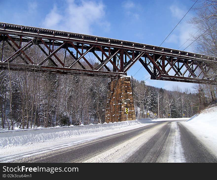 Train Trestle Bridge Over A Snowy Road