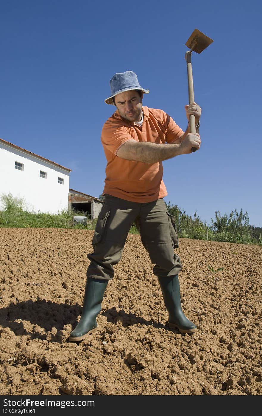 Farmer working on the farm with a Hoe