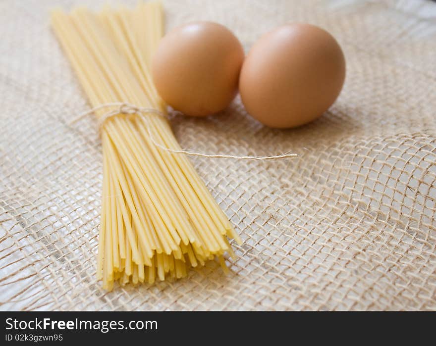 Pasta and egg on the natural sackcloth. Pasta and egg on the natural sackcloth