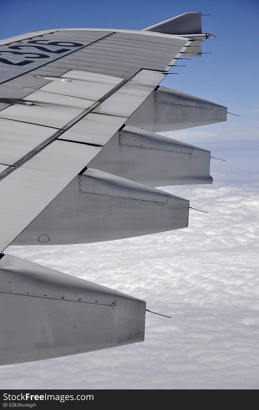 Aeroplane wing above white fluffy clouds. Aeroplane wing above white fluffy clouds.