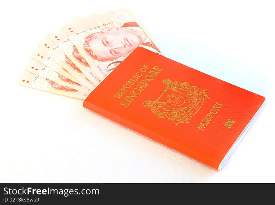 singapore Passport with singapore bank notes isolated on white background