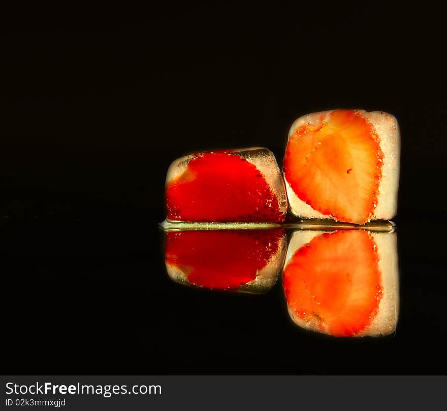 Strawberry in the ice on black background