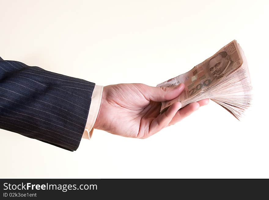 Businessman holding money stack isolated over white