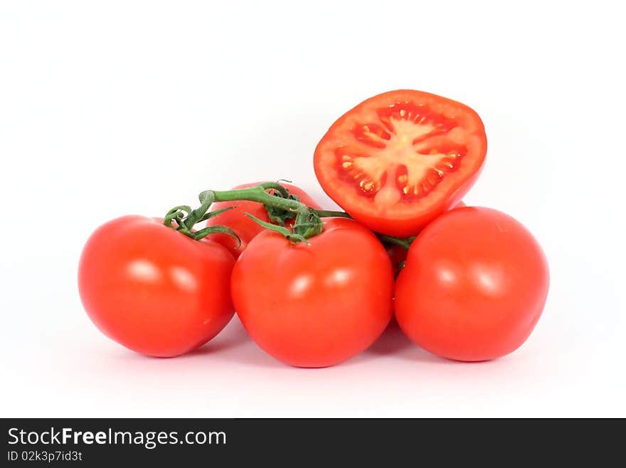 Red tomatoes on the branch isolated on white