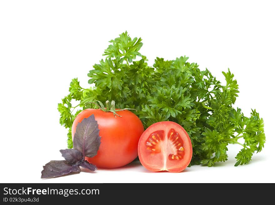 Tomatoes and parsley on a white background. Tomatoes and parsley on a white background