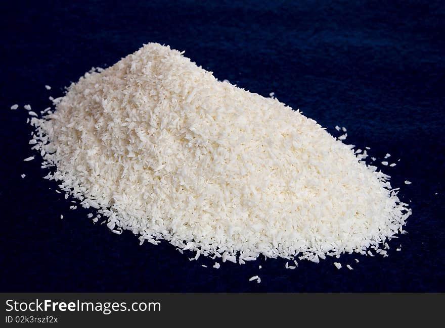 Medium desiccated coconut on dark background