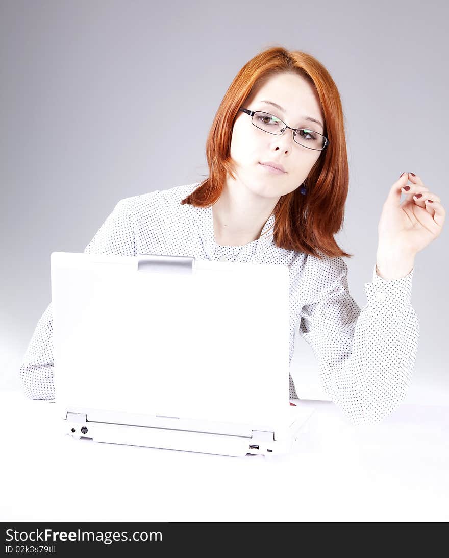 Red-haired girl with white notebook. Studio shot.