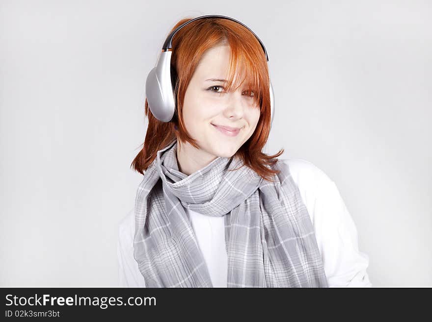 Girl with modern headphones. Studio shot.