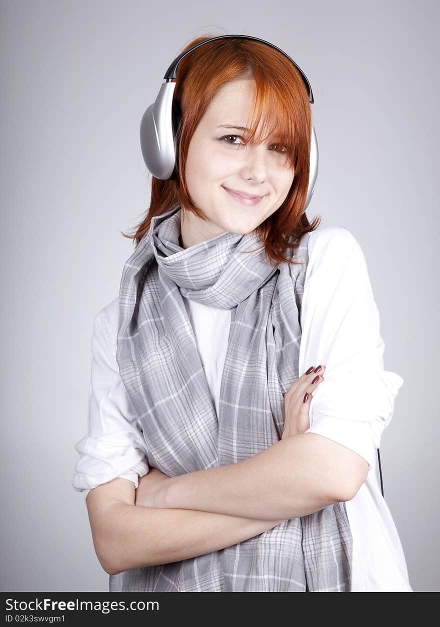 Girl with modern headphones. Studio shot.